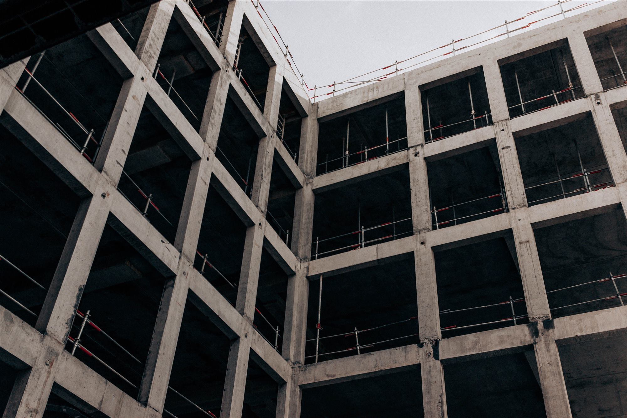 Looking up at the concrete frame of a building under construction